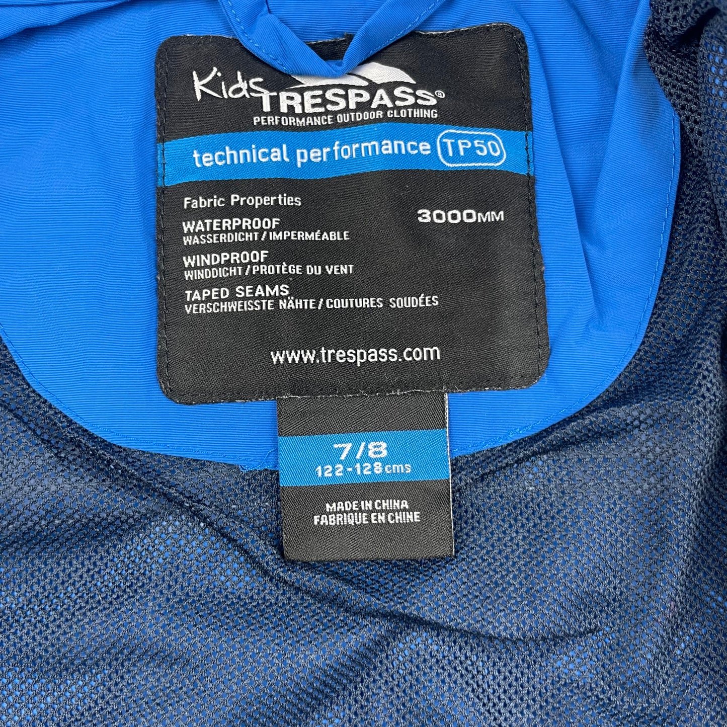 Blaue wasserdichte Kinderjacke von Trespass in Größe 122/128 – label