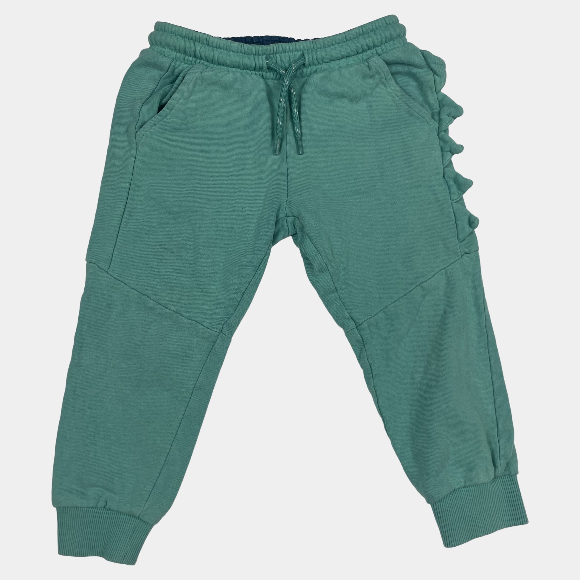 Grüne Jogginghose für Kinder mit seitlichen Dino-Details. – front