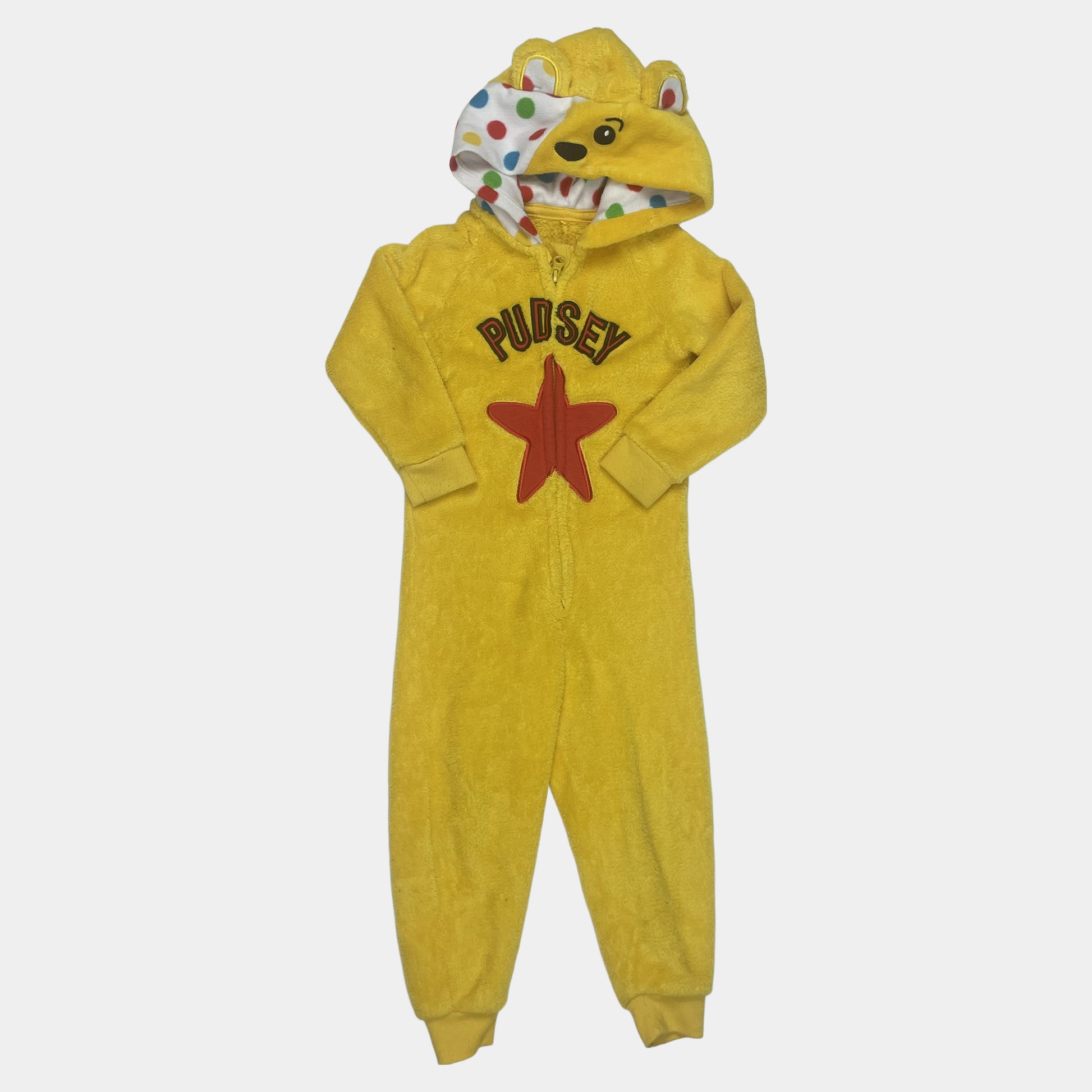 Gelber Overall mit Sternmotiv und bunten Punkten. – front