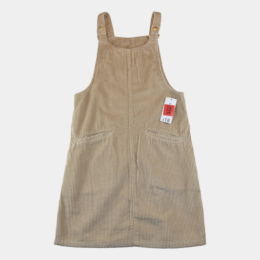 Beiges Cord-Latzkleid für Kinder mit Knopfträgern und seitlichen Taschen – front