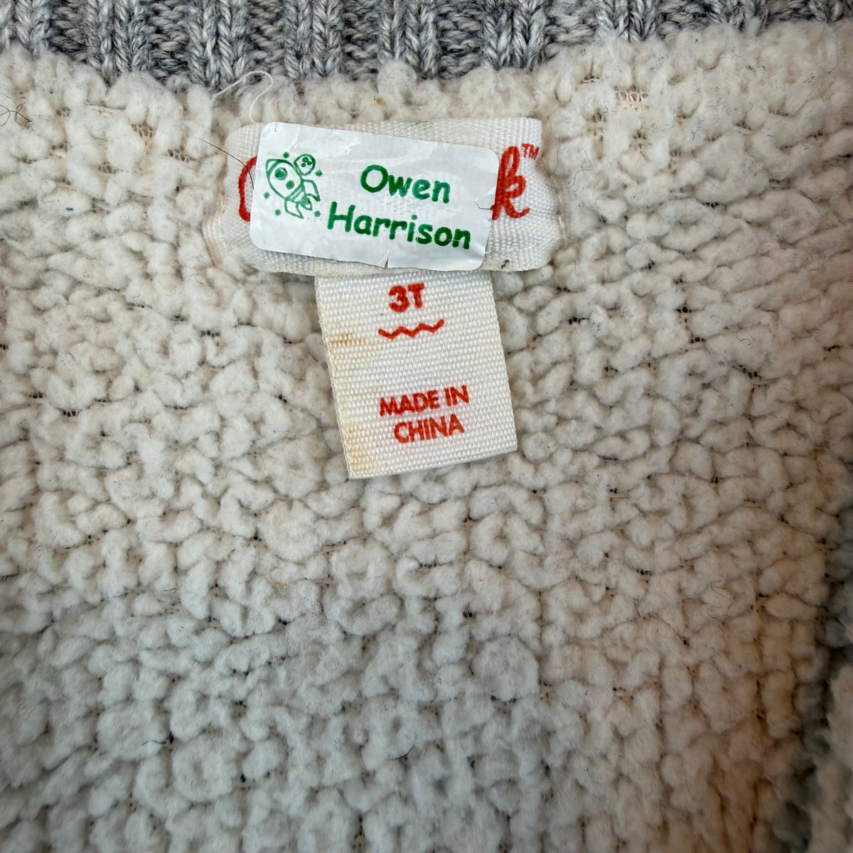 Rote und schwarze karierte Kinder-Strickjacke mit grauen Ärmeln und Reißverschluss – tag