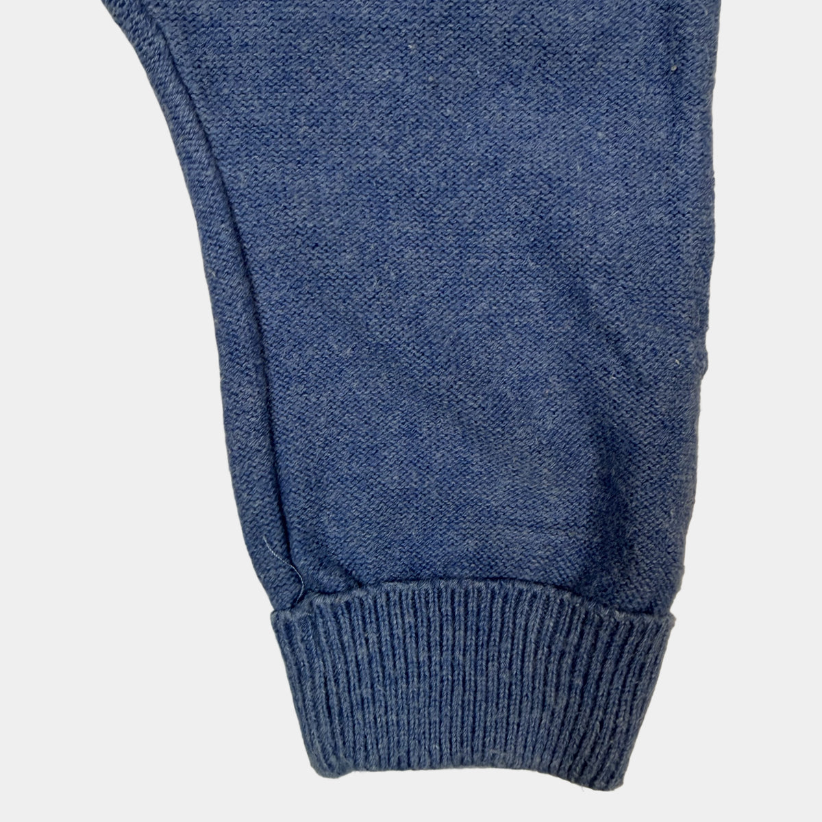 Blaue Baby-Latzhose aus Baumwolle mit gekreuzten Trägern und Knöpfen – detail