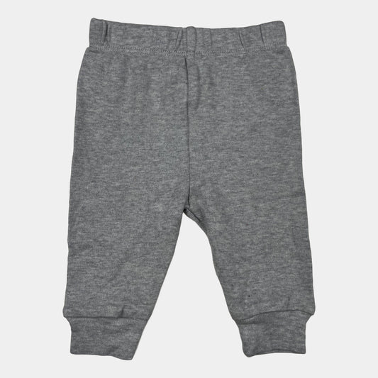 Graue Hose aus Baumwolle für Babys mit elastischem Bund und Bündchen. – front