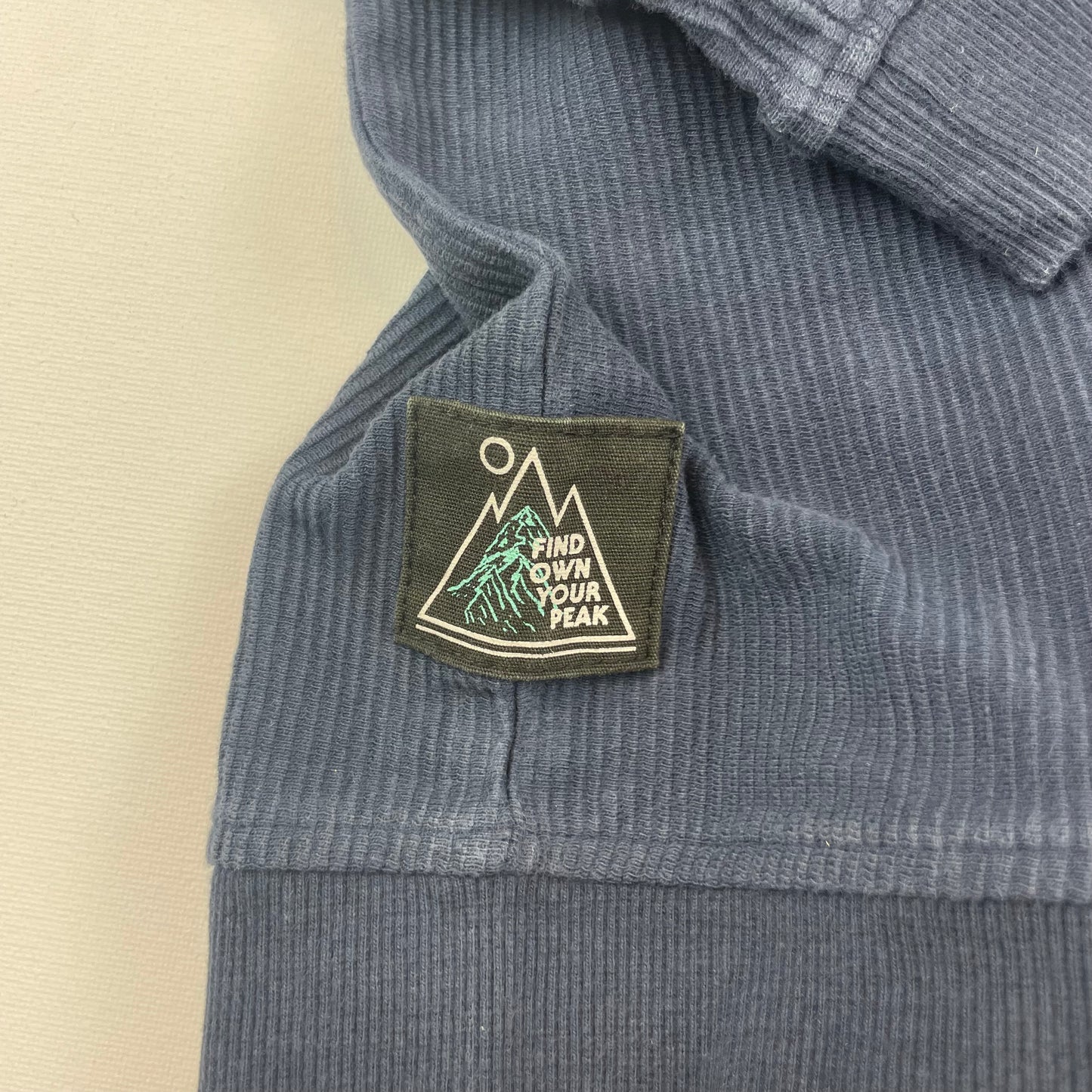 Dunkelblauer Baumwoll-Pullover mit Rippstruktur und kleiner Brusttasche – detail