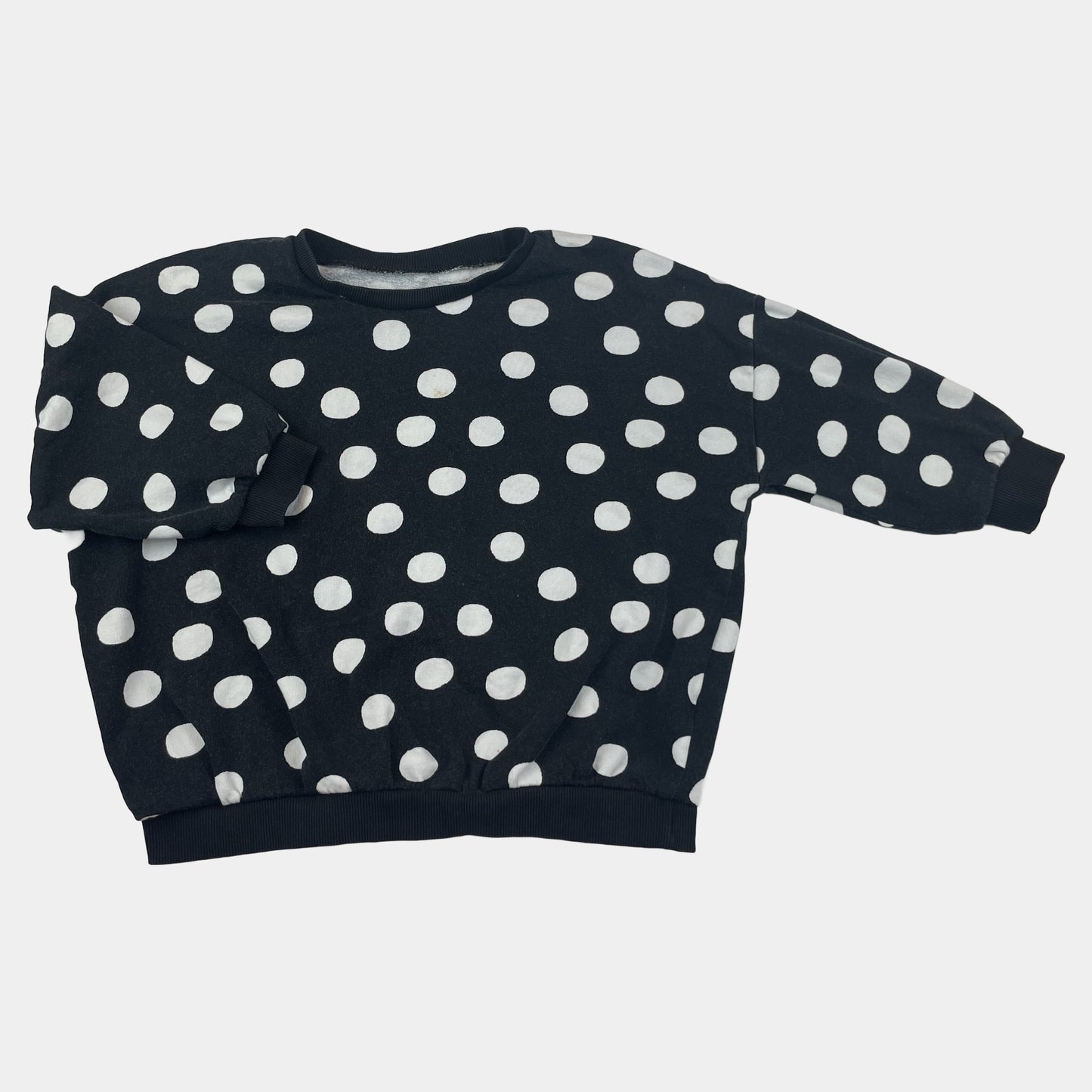 Schwarzer Baumwoll-Pullover mit weißen Punkten für Kinder. – front