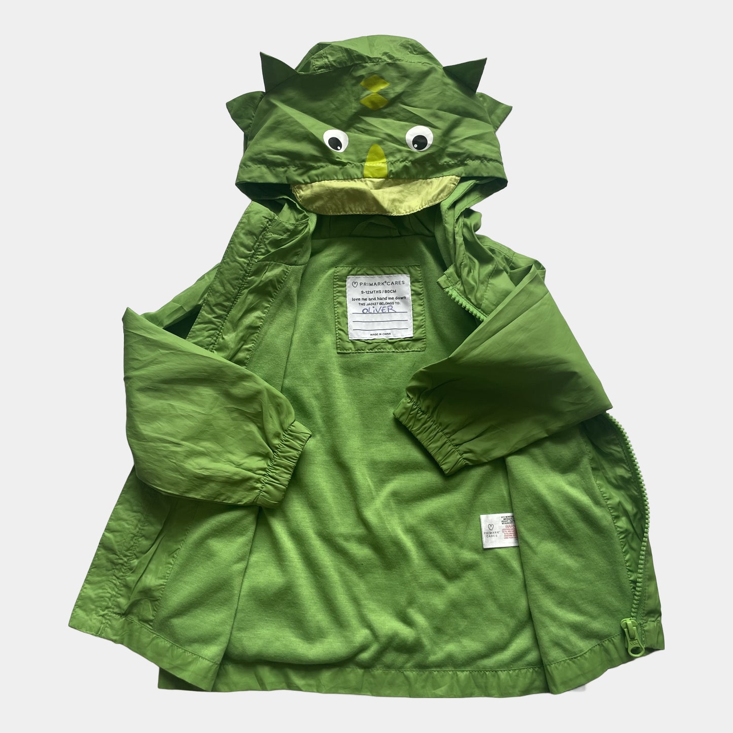 Grüne Polyester-Jacke mit Dino-Kapuze für Babys in Größe 9-12 Monate von Primark, aus zweiter Hand. – inside