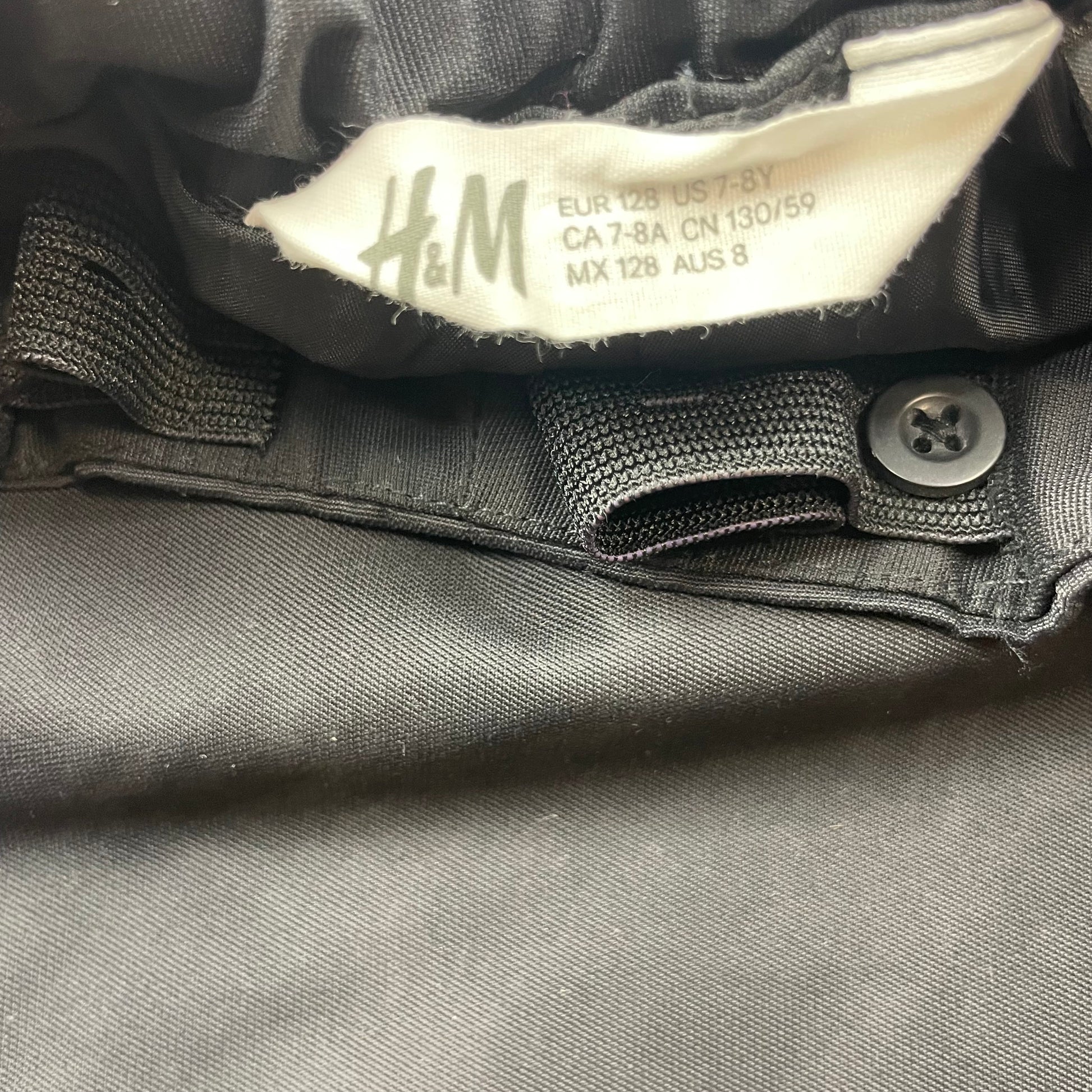 Schwarze Regenhose mit Reflektoren, Größe 128, von H&M – label