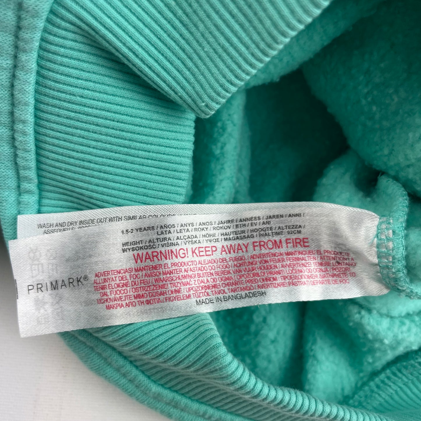 Mintgrüner Pullover aus Baumwoll-Polyester-Gemisch mit gerippten Bündchen für Kinder, Größe 1,5-2 Jahre. – label